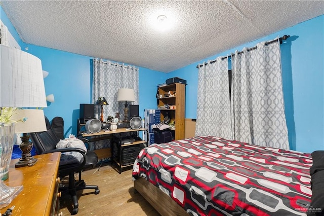 1914 W Barcelona Ave, Harlingen, TX 78550 - bedroom featuring wood finished floors and a textured ceiling