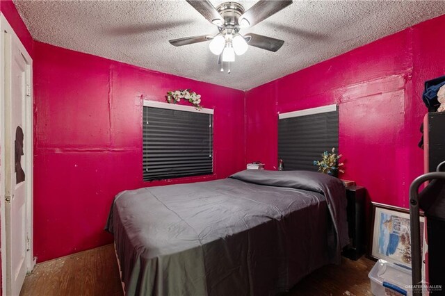 1914 W Barcelona Ave, Harlingen, TX 78550 - bedroom featuring wood finished floors, a textured ceiling, and ceiling fan