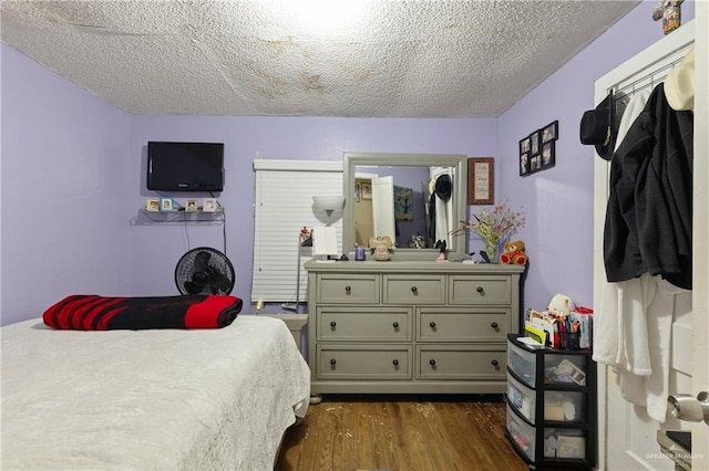 1914 W Barcelona Ave, Harlingen, TX 78550 - bedroom featuring a textured ceiling and dark wood finished floors