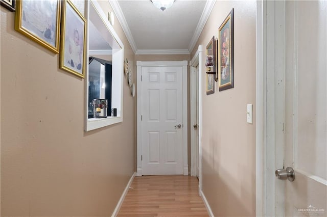 1914 W Barcelona Ave, Harlingen, TX 78550 - hallway featuring light wood-style flooring, crown molding, and baseboards