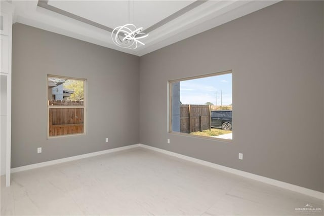 unfurnished room featuring an inviting chandelier