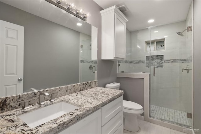 bathroom featuring an enclosed shower, vanity, and toilet