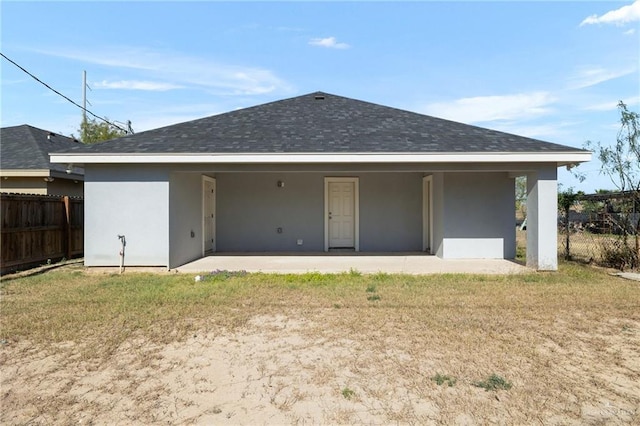 back of property featuring a patio and a lawn