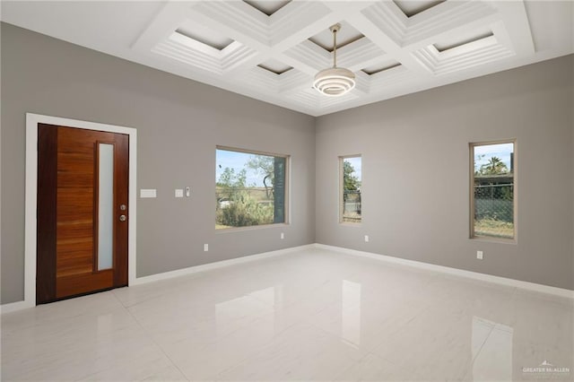 spare room featuring coffered ceiling, light tile patterned flooring, and beam ceiling