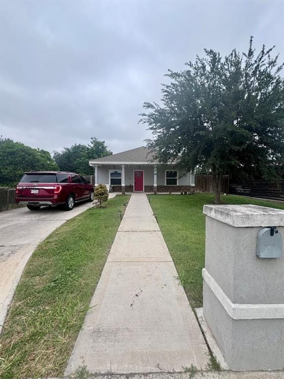 816 Leal St, Mission, TX 78572 - view of front of home featuring fence, a front yard, and concrete driveway