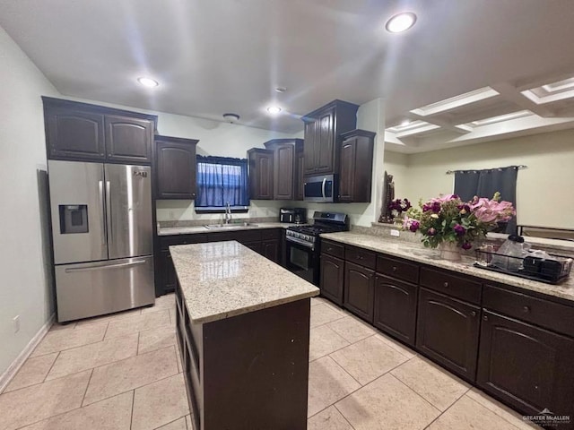 816 Leal St, Mission, TX 78572 - kitchen featuring a kitchen island, appliances with stainless steel finishes, light stone countertops, a sink, and light tile patterned flooring