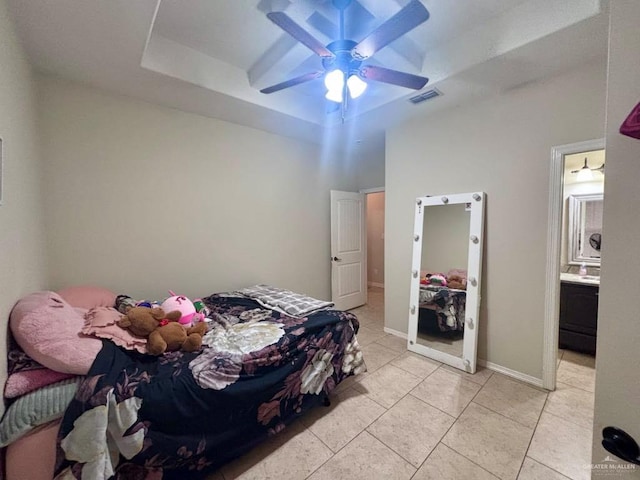 816 Leal St, Mission, TX 78572 - bedroom with visible vents, light tile patterned flooring, ensuite bathroom, a raised ceiling, and a ceiling fan