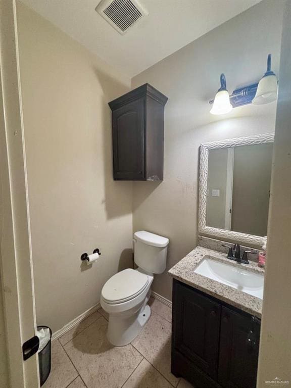 816 Leal St, Mission, TX 78572 - bathroom with tile patterned flooring, vanity, toilet, baseboards, and visible vents