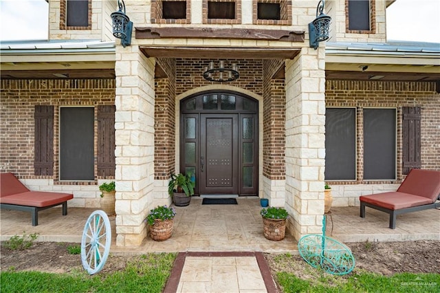 doorway to property with brick siding