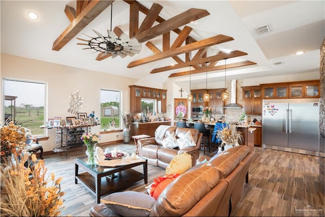 living room featuring visible vents, baseboards, recessed lighting, light wood-style floors, and vaulted ceiling with beams