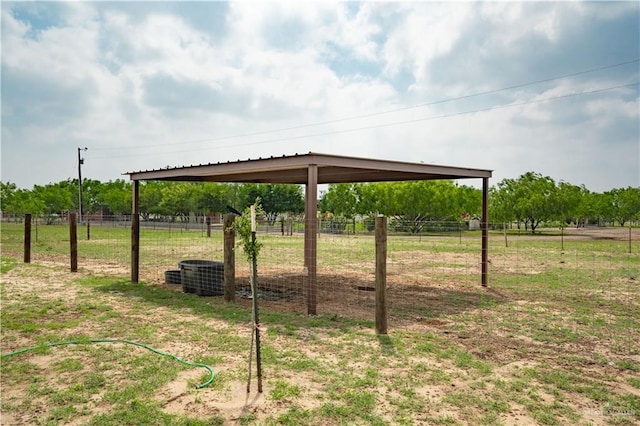 view of yard with fence and a rural view
