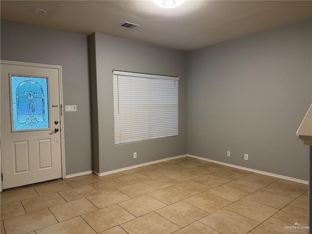 4717 Violet Ave, Mcallen, TX 78504 - entryway with visible vents, a textured ceiling, baseboards, and light tile patterned flooring