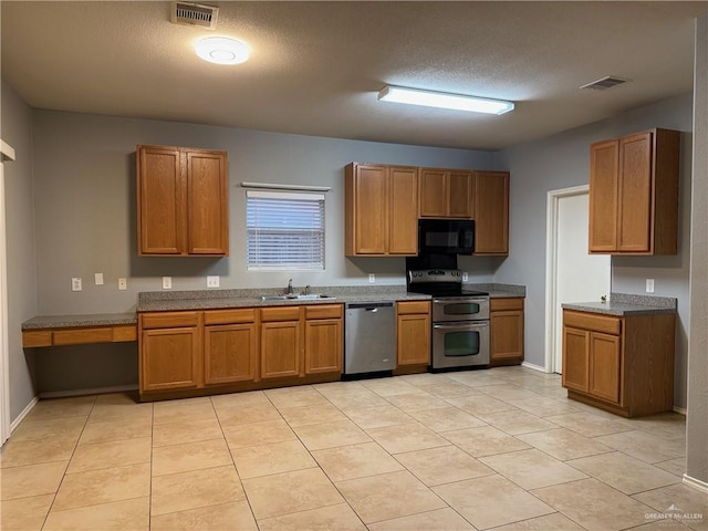 4717 Violet Ave, Mcallen, TX 78504 - kitchen with a sink, appliances with stainless steel finishes, brown cabinetry, and visible vents
