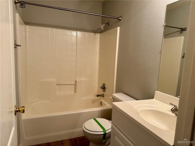 4717 Violet Ave, Mcallen, TX 78504 - full bathroom with vanity, a textured wall, shower / bathtub combination, wood finished floors, and toilet