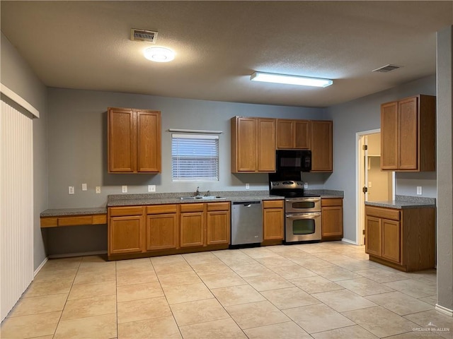 4717 Violet Ave, Mcallen, TX 78504 - kitchen with brown cabinets, a sink, stainless steel appliances, light tile patterned floors, and visible vents