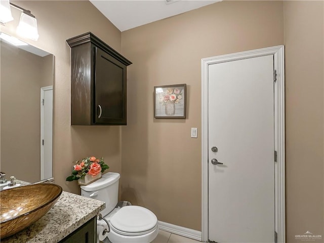 bathroom featuring tile patterned floors, vanity, and toilet