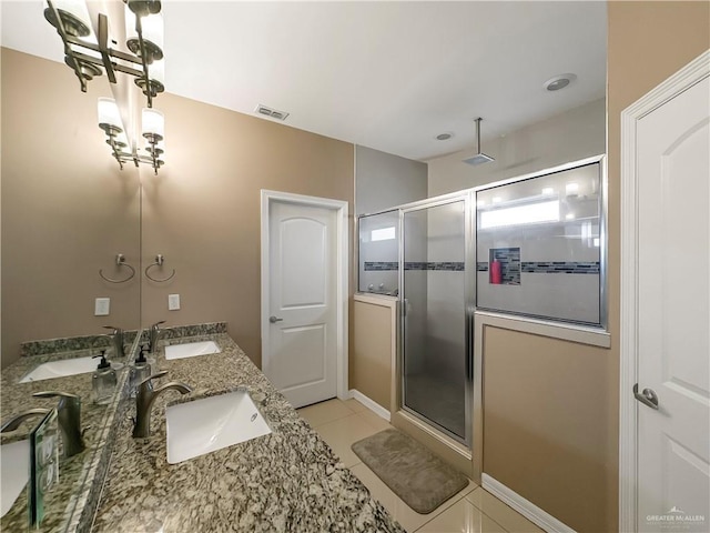 bathroom featuring tile patterned flooring, vanity, and a shower with shower door