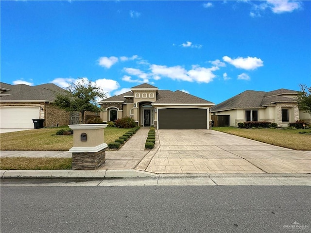 view of front facade featuring a garage and a front lawn