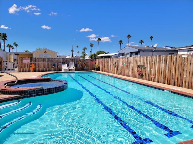 view of swimming pool with a community hot tub