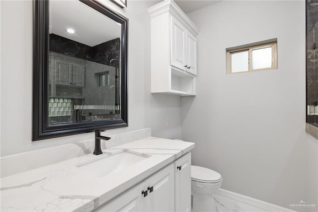 bathroom featuring vanity and toilet