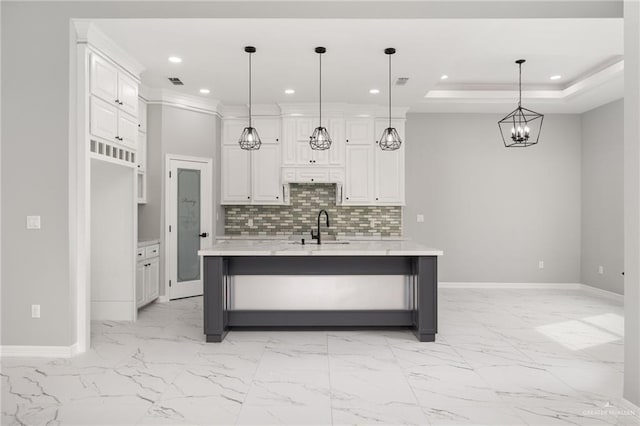 kitchen featuring a large island, decorative light fixtures, and white cabinets