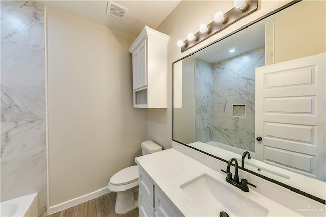 bathroom with wood-type flooring, toilet, and vanity