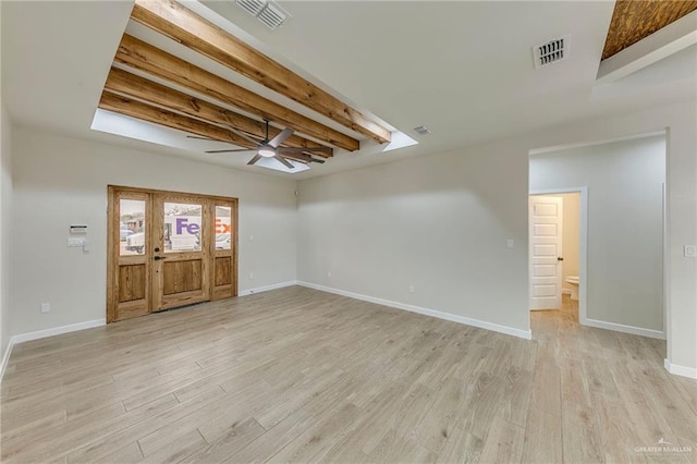 interior space with ceiling fan, beamed ceiling, and light hardwood / wood-style floors