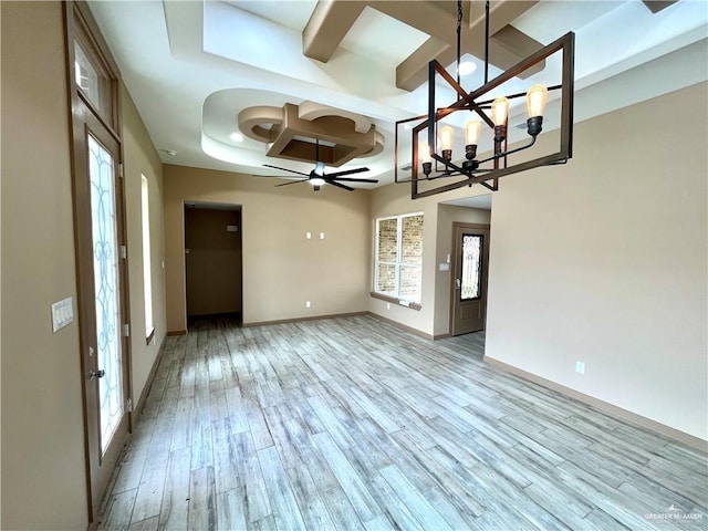 unfurnished dining area with ceiling fan with notable chandelier, light hardwood / wood-style floors, plenty of natural light, and coffered ceiling