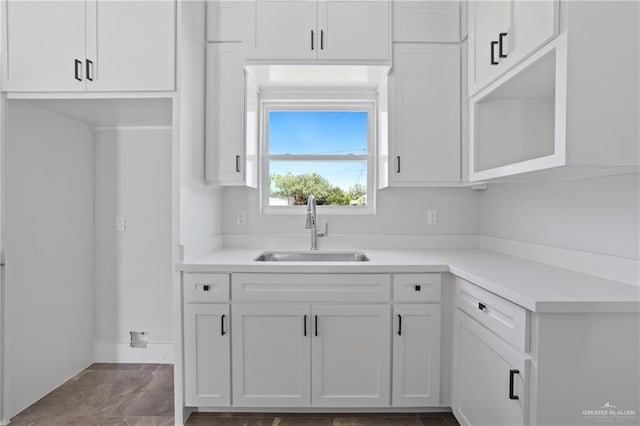 1003 Short Rd, San Juan, TX 78589 - kitchen featuring white cabinets, baseboards, a sink, and light countertops