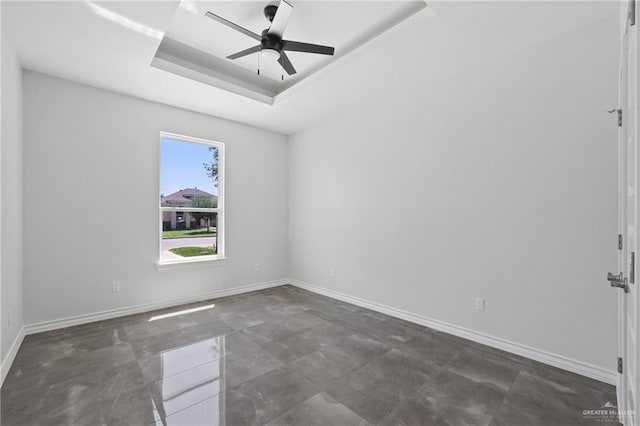 1003 Short Rd, San Juan, TX 78589 - spare room with a tray ceiling, a ceiling fan, and baseboards