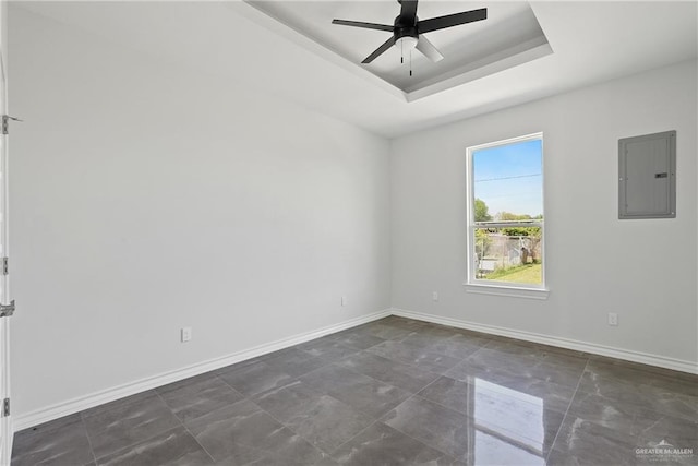 1003 Short Rd, San Juan, TX 78589 - spare room featuring a tray ceiling, electric panel, a ceiling fan, and baseboards