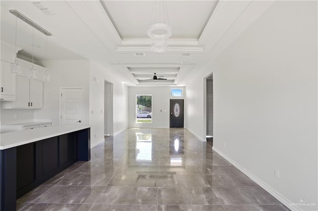 1003 Short Rd, San Juan, TX 78589 - interior space with marble finish floor, light countertops, a raised ceiling, visible vents, and white cabinetry