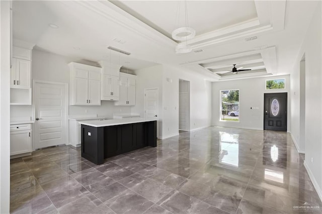 1003 Short Rd, San Juan, TX 78589 - kitchen featuring a center island, open floor plan, marble finish floor, a raised ceiling, and white cabinets