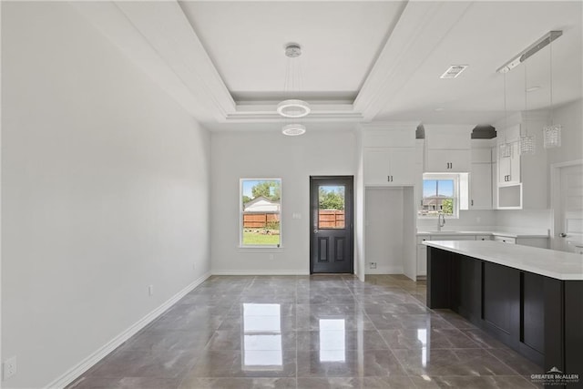 1003 Short Rd, San Juan, TX 78589 - kitchen with white cabinets, marble finish floor, pendant lighting, and light countertops