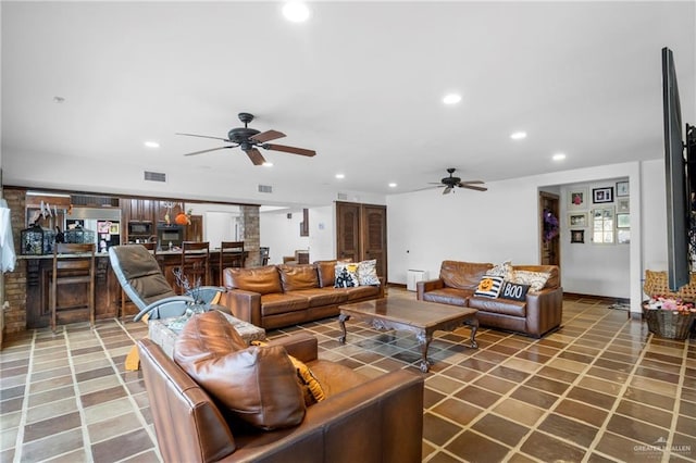 tiled living room featuring ceiling fan