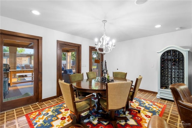 tiled dining space with a notable chandelier