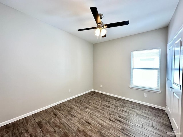 empty room featuring ceiling fan and dark hardwood / wood-style floors