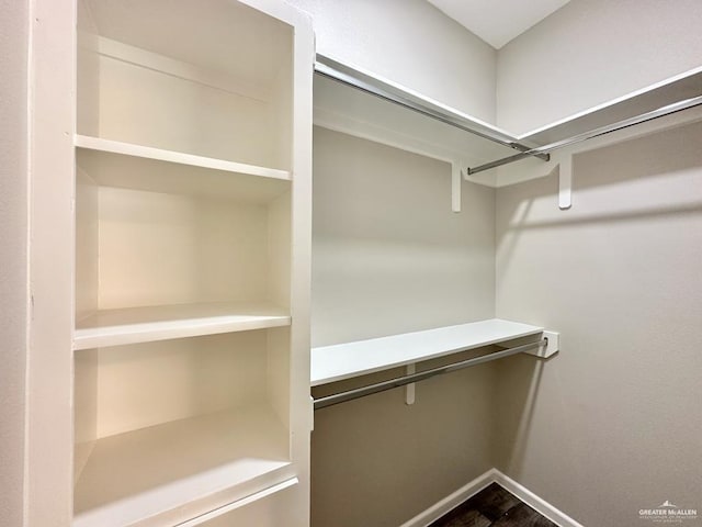 spacious closet featuring hardwood / wood-style floors