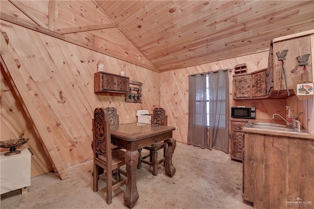 dining space featuring sink, wooden walls, lofted ceiling, and wood ceiling