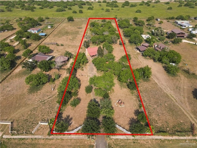 birds eye view of property with a rural view