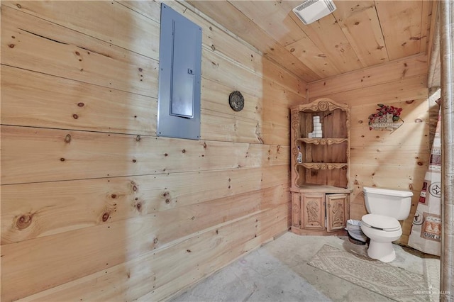 bathroom featuring wood walls, toilet, concrete flooring, and wood ceiling