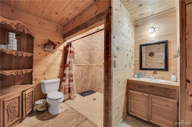 bathroom with wood walls, vanity, wood ceiling, and toilet