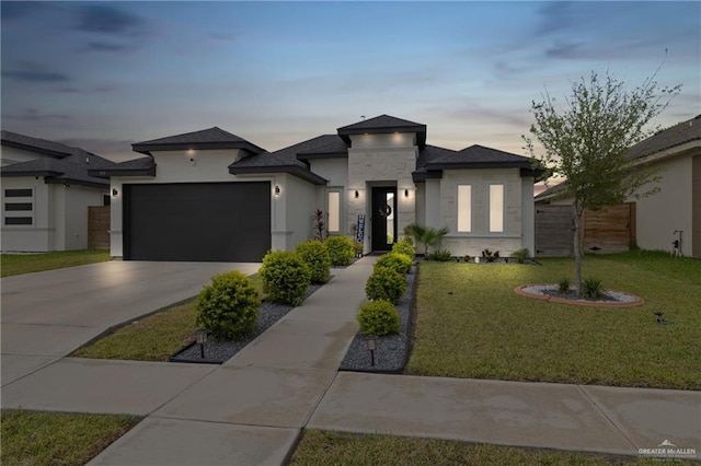 915 Rockford Dr, Alton, TX 78573 - prairie-style home with concrete driveway, an attached garage, stucco siding, and stone siding