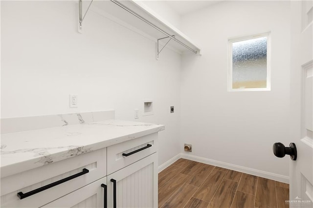 clothes washing area with washer hookup, cabinet space, baseboards, hookup for an electric dryer, and dark wood-style flooring
