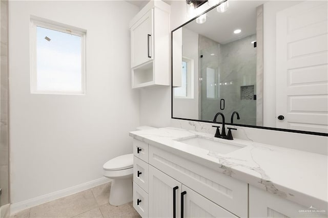 full bathroom featuring toilet, a marble finish shower, tile patterned flooring, baseboards, and vanity