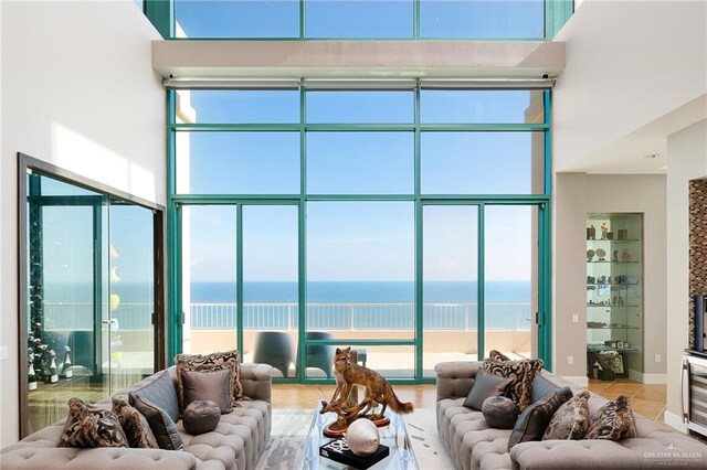 310-A Padre Blvd Unit 3102, South Padre Island, TX 78597 - tiled living area with a water view and a towering ceiling