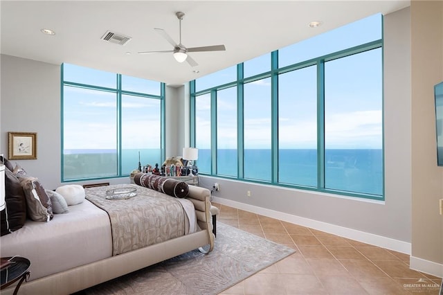 310-A Padre Blvd Unit 3102, South Padre Island, TX 78597 - bedroom with light tile patterned floors, baseboards, ceiling fan, and a water view