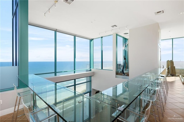 310-A Padre Blvd Unit 3102, South Padre Island, TX 78597 - stairway featuring rail lighting, tile patterned floors, and a water view
