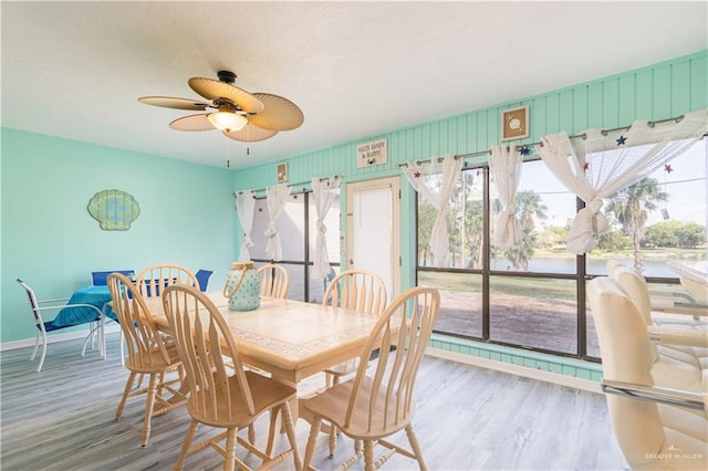 dining room with hardwood / wood-style flooring and ceiling fan