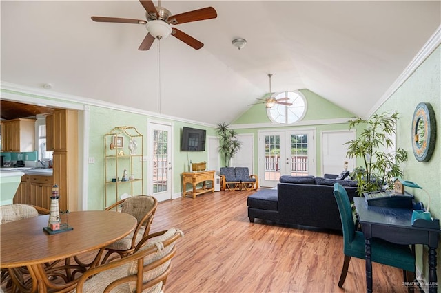 dining space featuring high vaulted ceiling, french doors, sink, ceiling fan, and light wood-type flooring